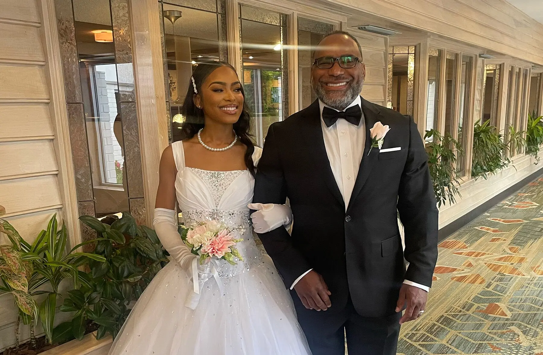 Full Implant Choice patient smiling proudly at a wedding after full-arch treatment